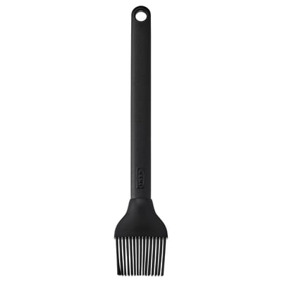 Black silicone grill brush with long handle and hanging hole, ideal for spreading liquids on grills.