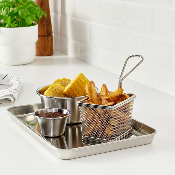 Stainless steel serving tray with baskets and sauce dish, perfect for outdoor dining. Contains grilled food and corn.
