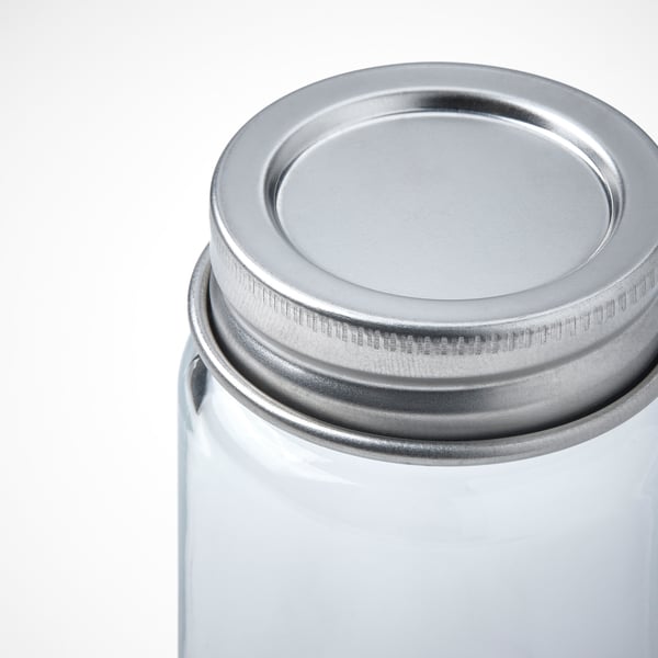 Clear glass jar with stainless steel lid, seen from top right. High-quality, durable, and functional design.