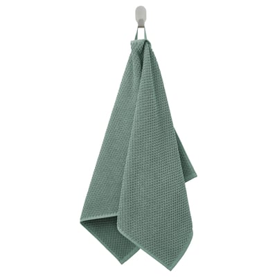 Green GULVIAL cotton towel hangs neatly on hook, soft and textured.