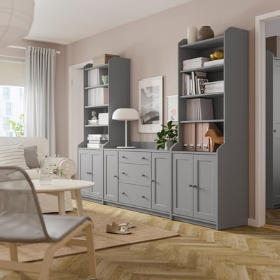 Modern living room with grey HAUGA storage units, including shelves, drawers, lamp, and plants.