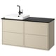 HAVBÄCK beige bathroom cabinet with black countertop and square white sink.