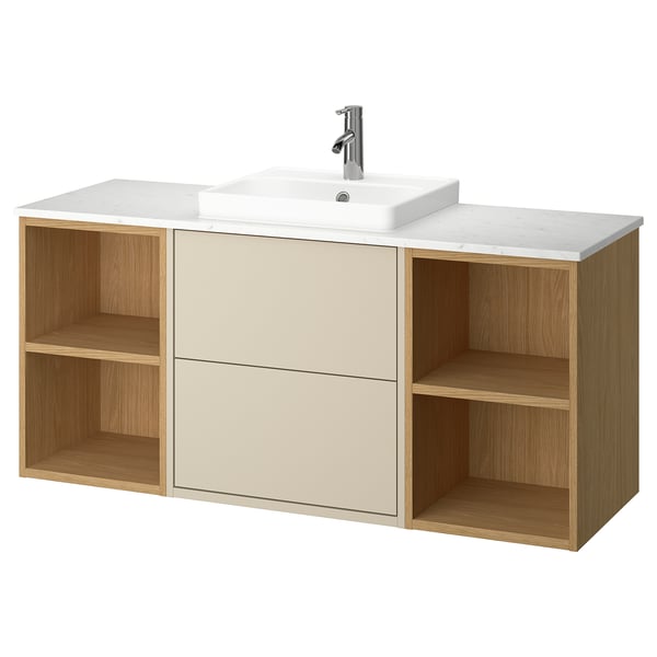 A HAVBÄCK bathroom vanity in beige with wooden accents, a ceramic sink, and open storage.