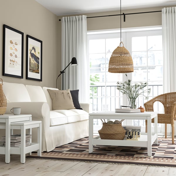 Modern living room with white sofa, HAVSTA coffee table, pendant light, and large window.