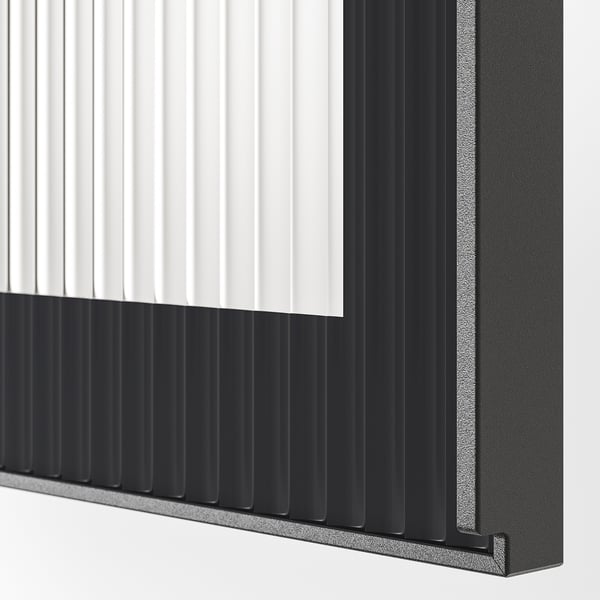 Black aluminium-framed glass door with vertical reeded texture for privacy and style.