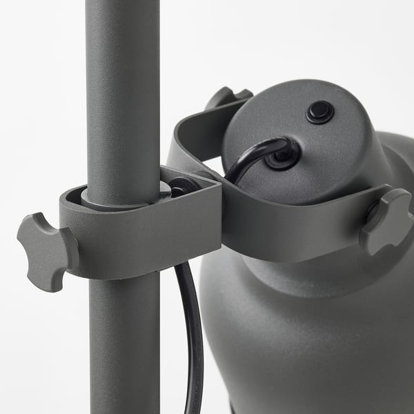 Adjustable metal lamp with knobs and clamps for secure positioning.