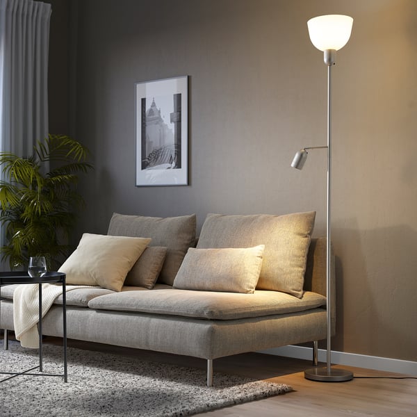 Grey HEKTOGRAM floor lamp with adjustable light beside sofa