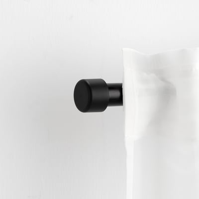 HELTUSS finials in black, minimalist design. Sized smaller than a fist, fits curtain rod for home decor.