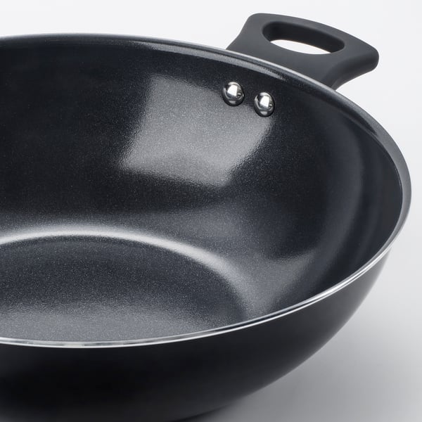 Black wok pan with two sturdy handles and a smooth, non-stick interior, perfect for cooking without spills.