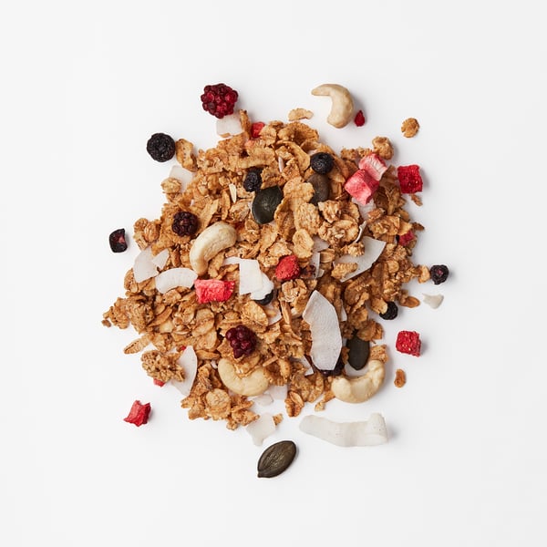 Crispy granola mix featuring cashew nuts, hazelnuts, dried berries, and coconut flakes.
