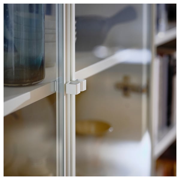 The HÖGBO glass door for a billy bookcase, featuring a white frame and adjustable hinges.