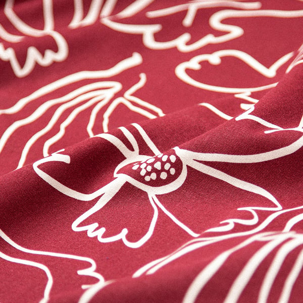 Red recycled cotton tablecloth with intricate white floral pattern, showcasing high-quality craftsmanship and eco-friendly materials.