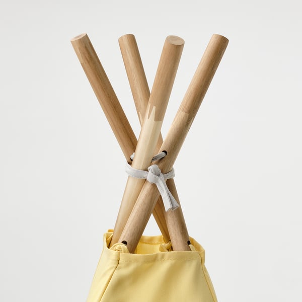 Wooden tent poles tied together, inserted into yellow fabric bag.