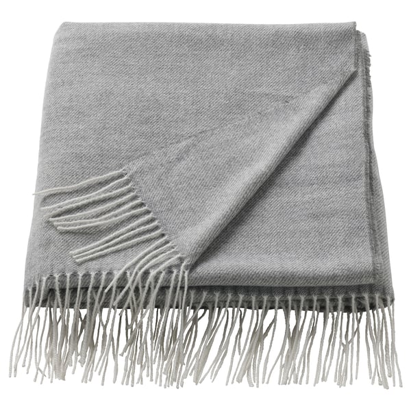 A folded grey HOLMVI throw blanket with fringed edges, made from recycled polyester.