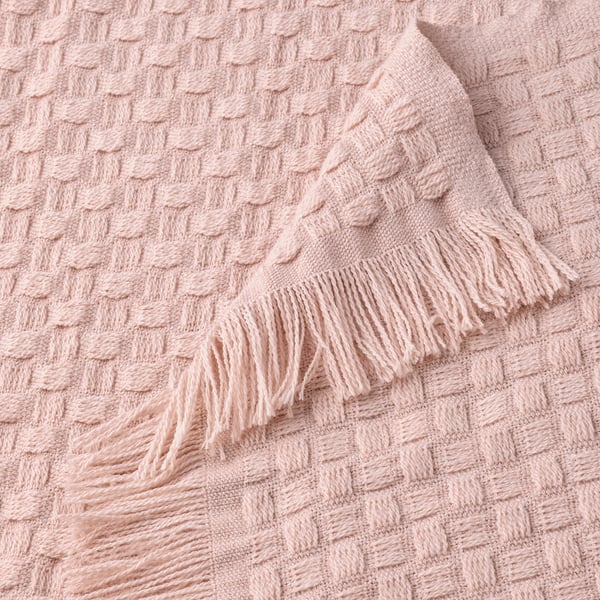 Soft, light pink throw blanket with textured basket weave and playful fringes, made from recycled polyester.