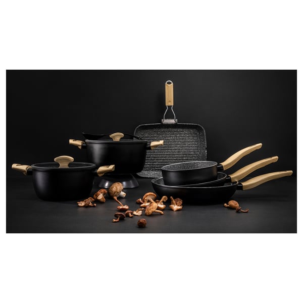 Black cookware set with wooden handles and lids. Includes pots and pans with non-stick coating. Mushrooms scattered around.