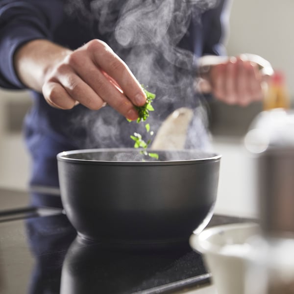 Cooking herbs on stove.