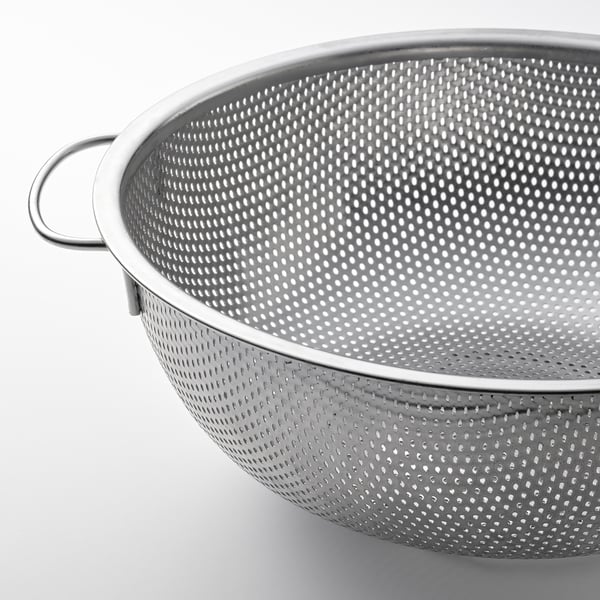 Stainless steel colander with perforated design and handles for easy draining.