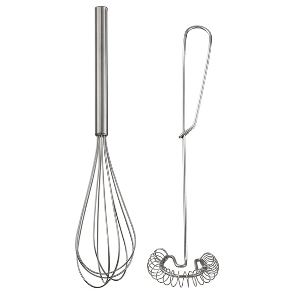 Two stainless steel kitchen tools: a whisk and a spiral masher. Imaged against white.