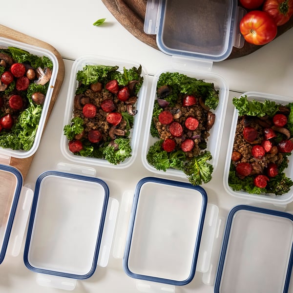 Six meal prep containers with broccoli, lentils, and sausage, ready for storage or transport.