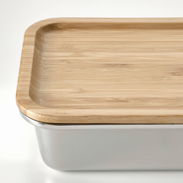 Stainless steel food container with tightly fitted bamboo lid.