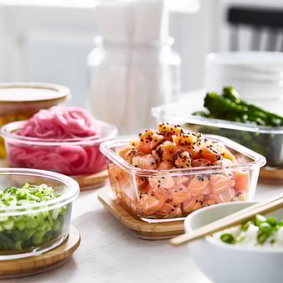 Assorted glass containers with plant-based fish, pickled veggies, and seasonings, prepared for meal prep.