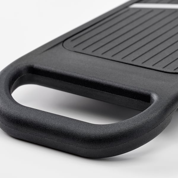 Black cutting board with handle, textured surface for grip, dial feature, sleek design.