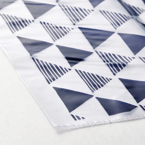 Geo-patterned fabric, textured in triangles and stripes, displays high-quality design and craftsmanship.