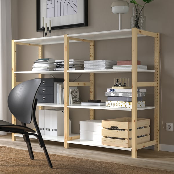 Wooden IVAR bookshelf with books, crates & chair.