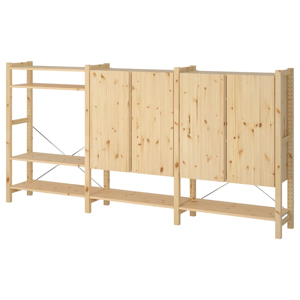 An IVAR wooden storage unit in natural wood colour, featuring multiple shelves and cabinets with a simple, sturdy design.