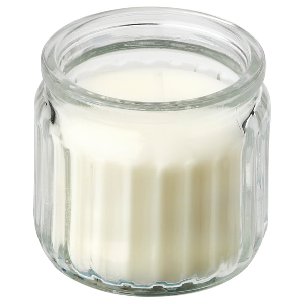 JÄMLIK scented candle in clear glass, white wax, ribbed design, small cylindrical shape.