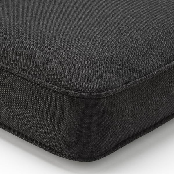 Black outdoor cushion cover, neatly stitched with durable fabric, designed for comfort and easy cleaning.