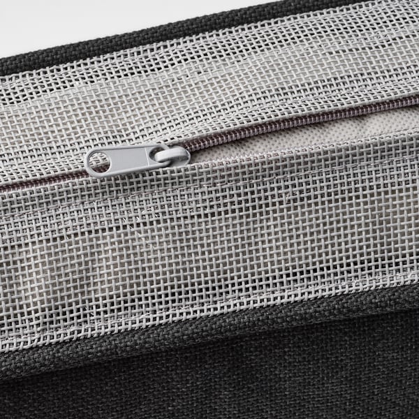 Zip on mesh fabric bag, black trim, close-up.