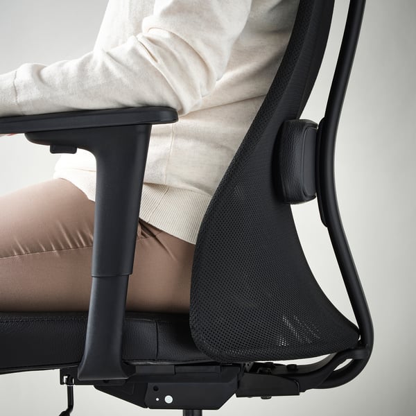 Person sitting in JÄRVFJÄLLET office chair, showing adjustable lumbar support.