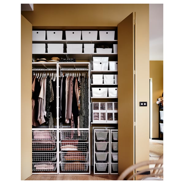 Organised closet using JONAXEL storage system with white and black baskets, rails for clothes, and drawers.