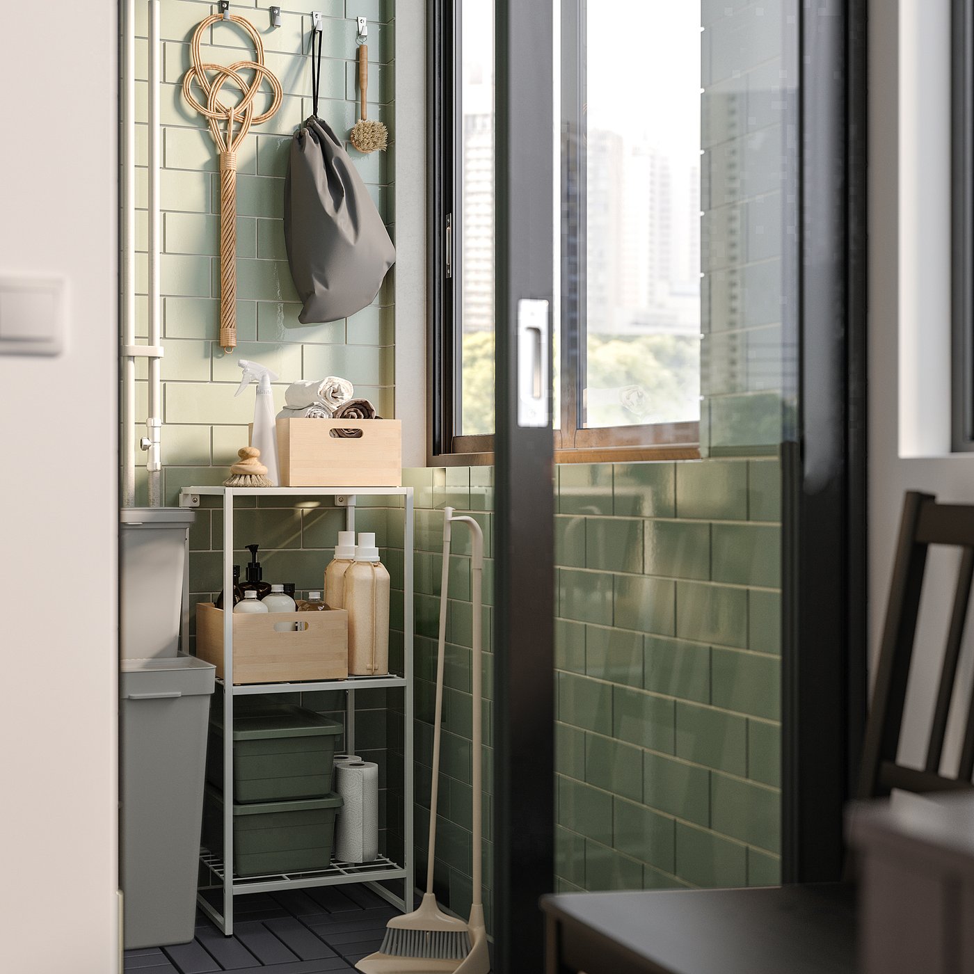 Green tiled balcony with JOSTEIN storage shelf, hanging tools, and cleaning supplies.
