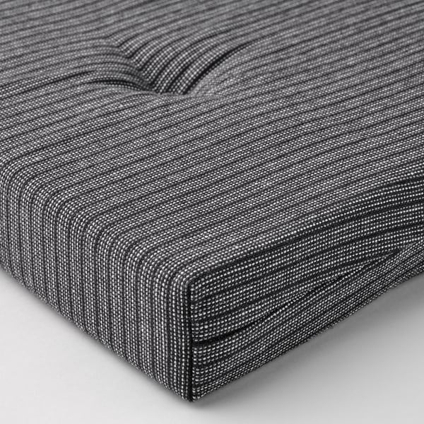 Close-up view of cushioned seat top, showcasing comfortable, even foam filling.