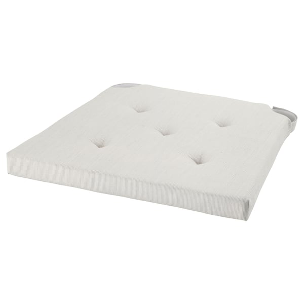 A light grey JUSTINA cushion with a tufted design. It is rectangular with rounded corners and made from cotton.