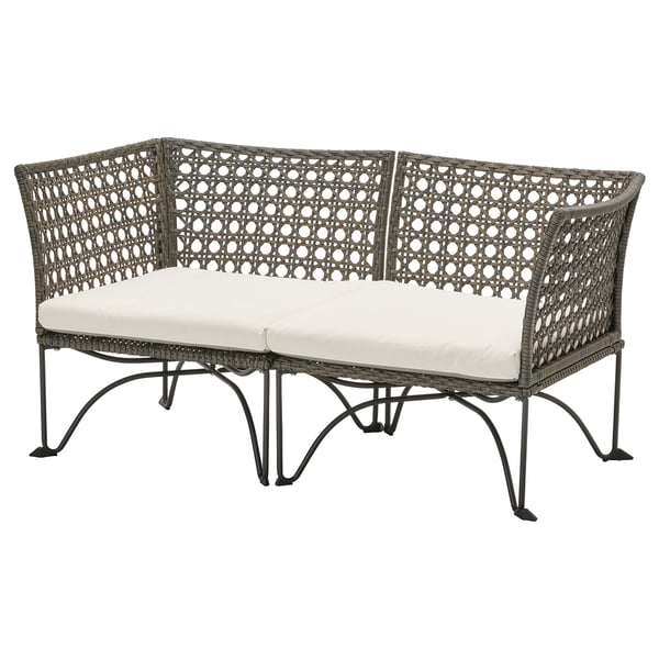 Jutholmmen outdoor sofa, beige cushion, woven plastic rattan, modern curved design.
