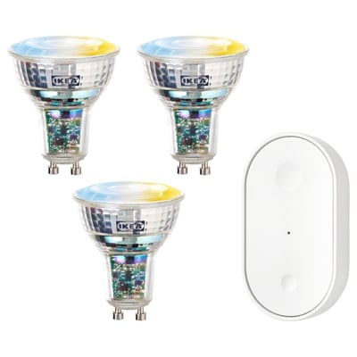 Three colorful ikea smart bulbs and a white remote control.