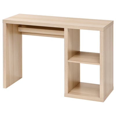 A KALLAX light brown wooden desk with a simple, rectangular design. It open shelving and a cable outlet at the back.