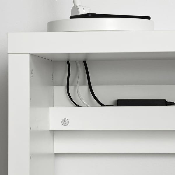 White KALLAX shelf with cord management, showing organised cables.