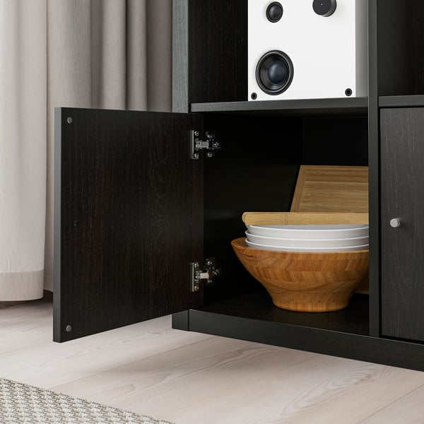 Open storage cabinet with wooden bowls and plates. Part of IKEA KALLAX series.