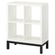 A white KALLAX shelving unit with a black underframe. It has an open, airy design with multiple compartments.