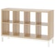 An empty, light wooden KALLAX shelving unit with white legs, featuring multiple cube shelves.