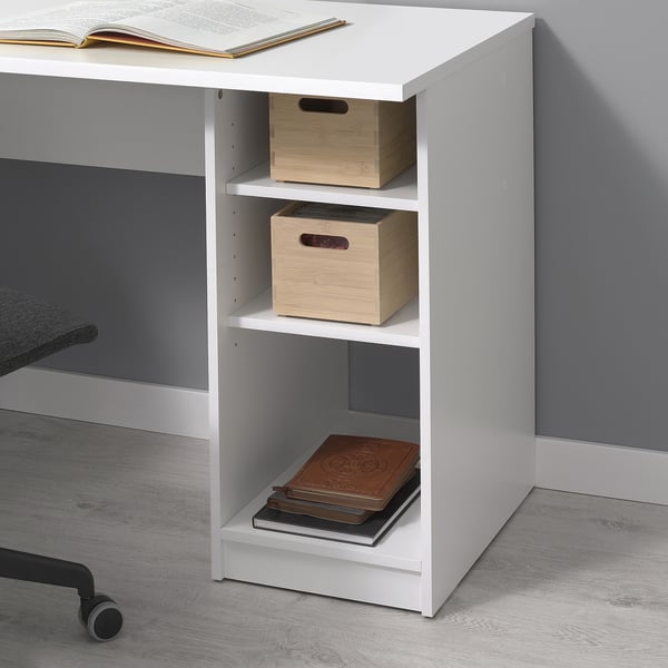 White desk with shelves and bins for storage, showcasing organised workspace.