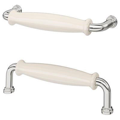 Two white porcelain-like handles with chrome accents, ideal for kitchen cabinets, blending traditional charm with modern utility.