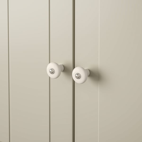 White knobs with chrome on light wood.