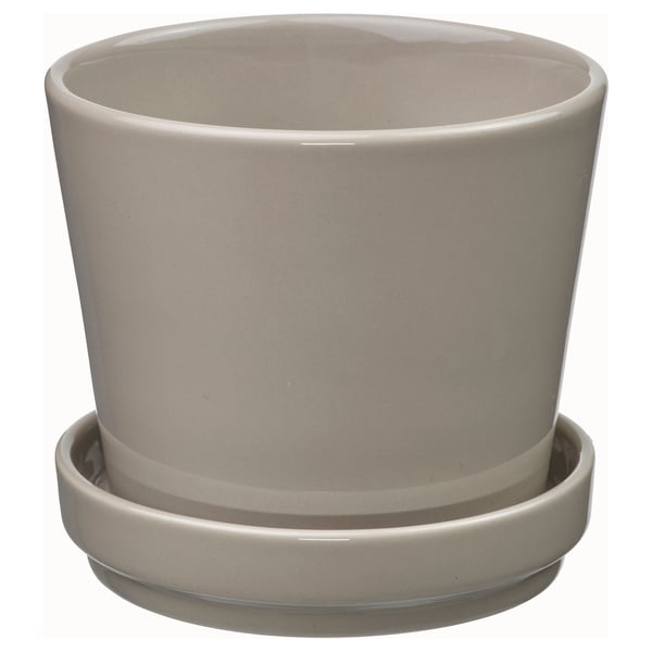 Beige stoneware planter with saucer, cylindrical design, drain holes.