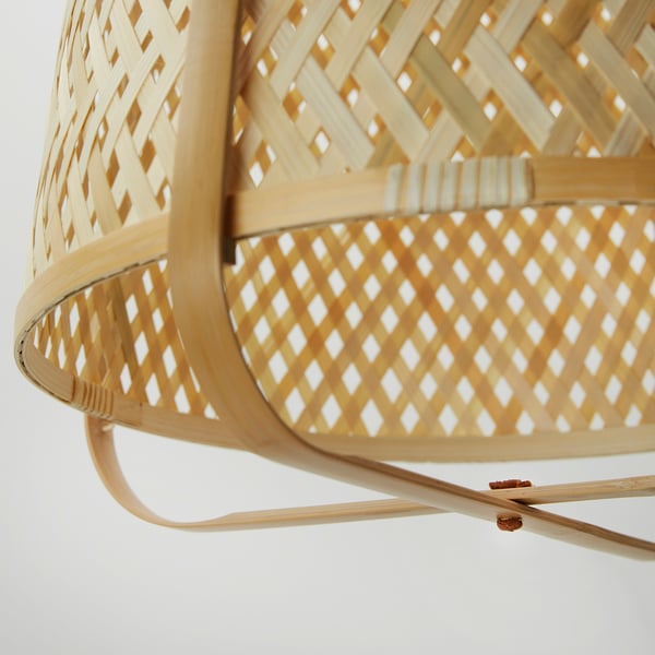 Close-up of intricately woven bamboo pendant lamp, showcasing natural texture and warm lighting.